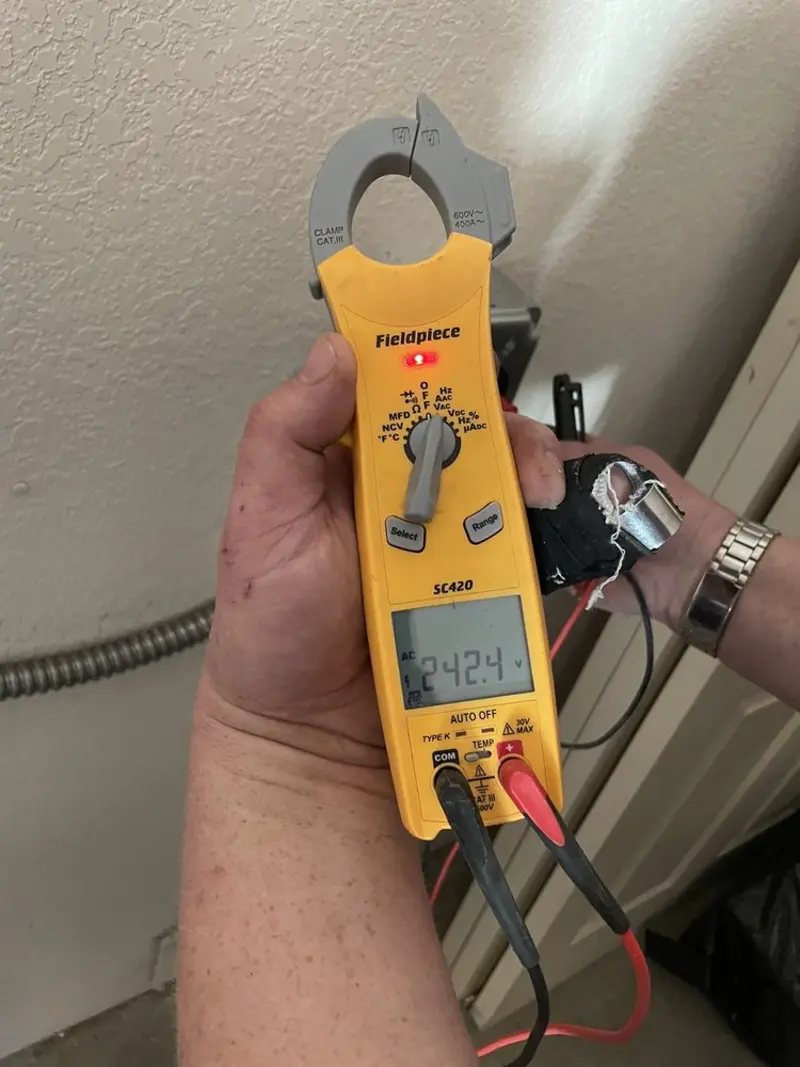 Voltage testing with clamp meter during Generator Installation in Naples Manor